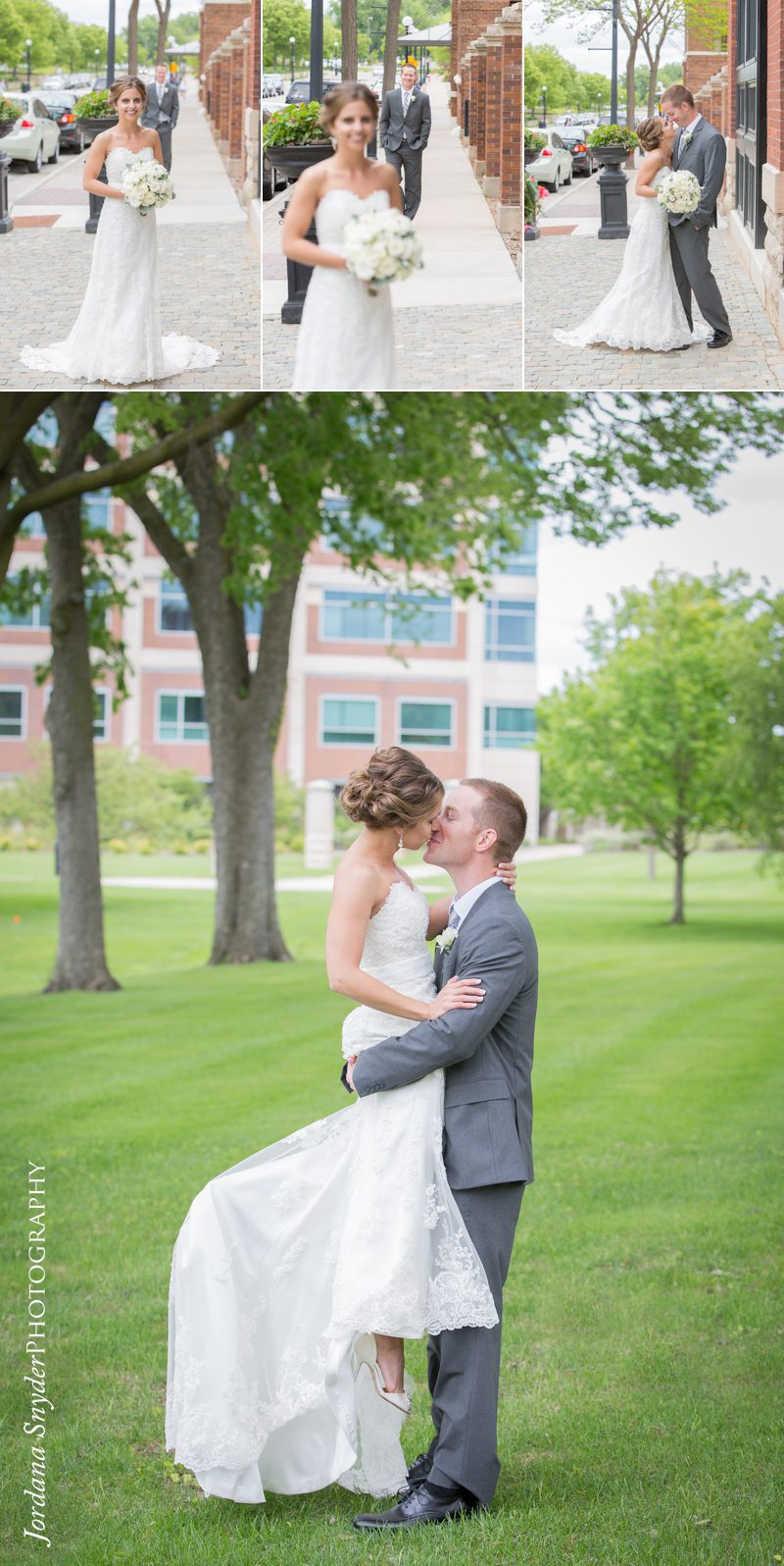 A bride and groom kissing in the grass.