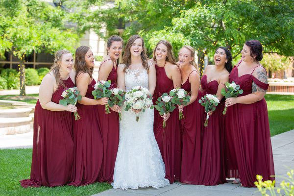 A bride and her bridesmaids in red dresses