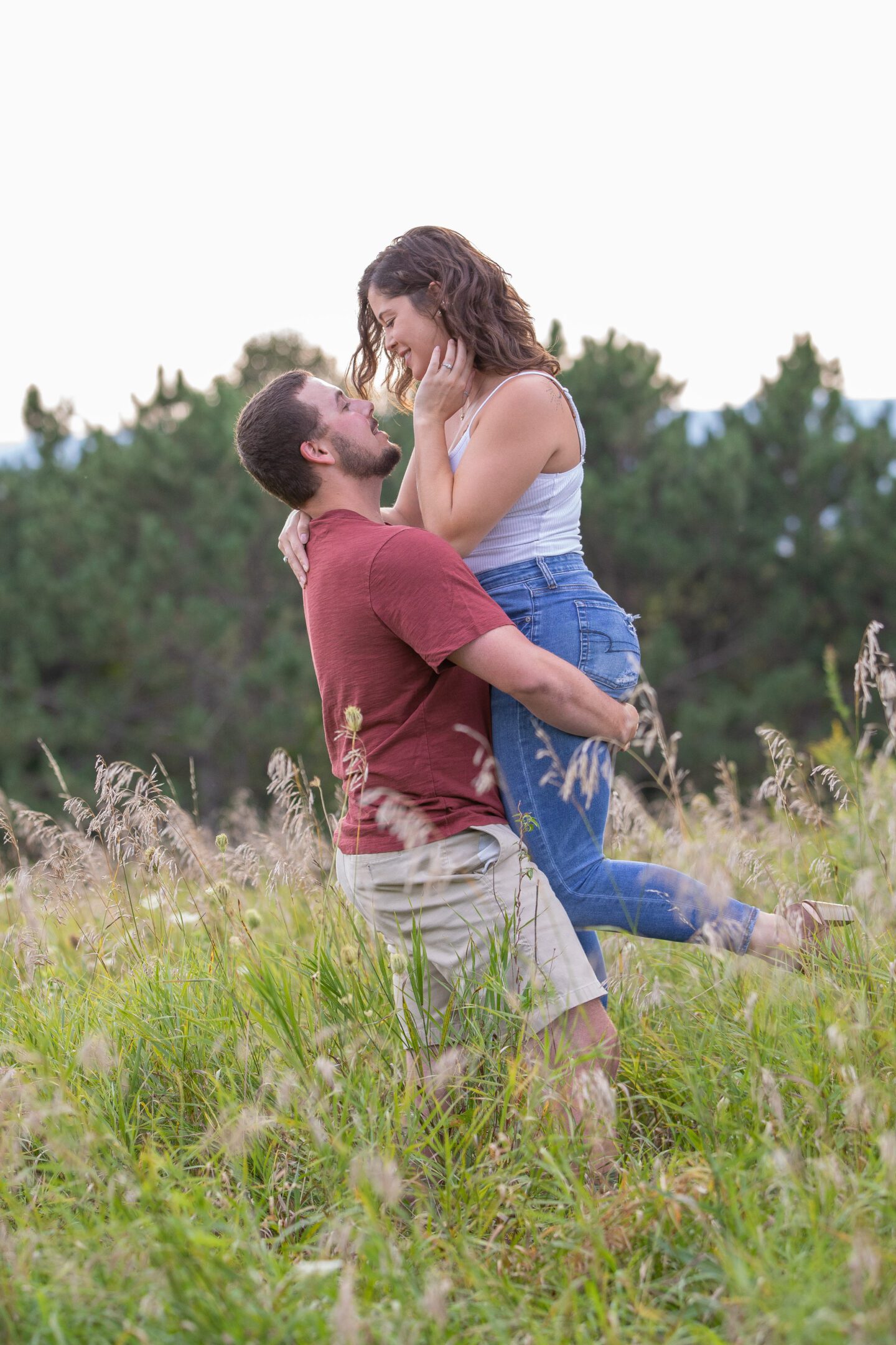 Romantic couple embracing in grassy field