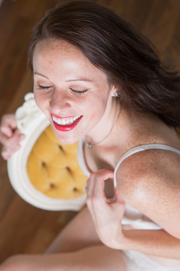 Smiling woman in white lingerie on chair