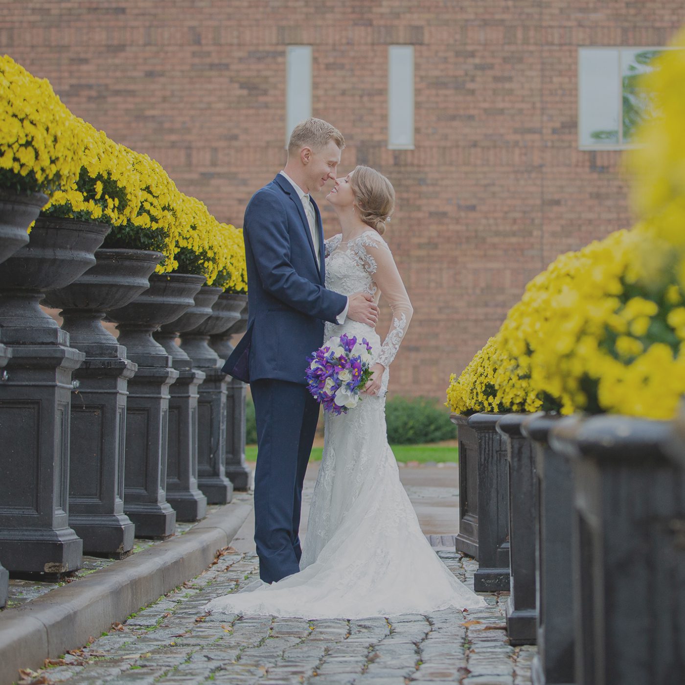 A bride and groom standing next to each other.
