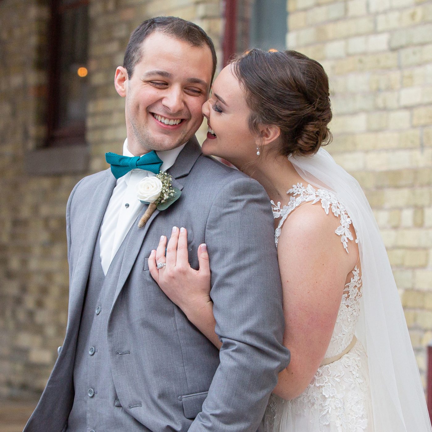 A man and woman embracing each other outside.