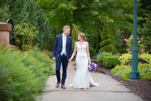 A man and woman walking down the sidewalk.