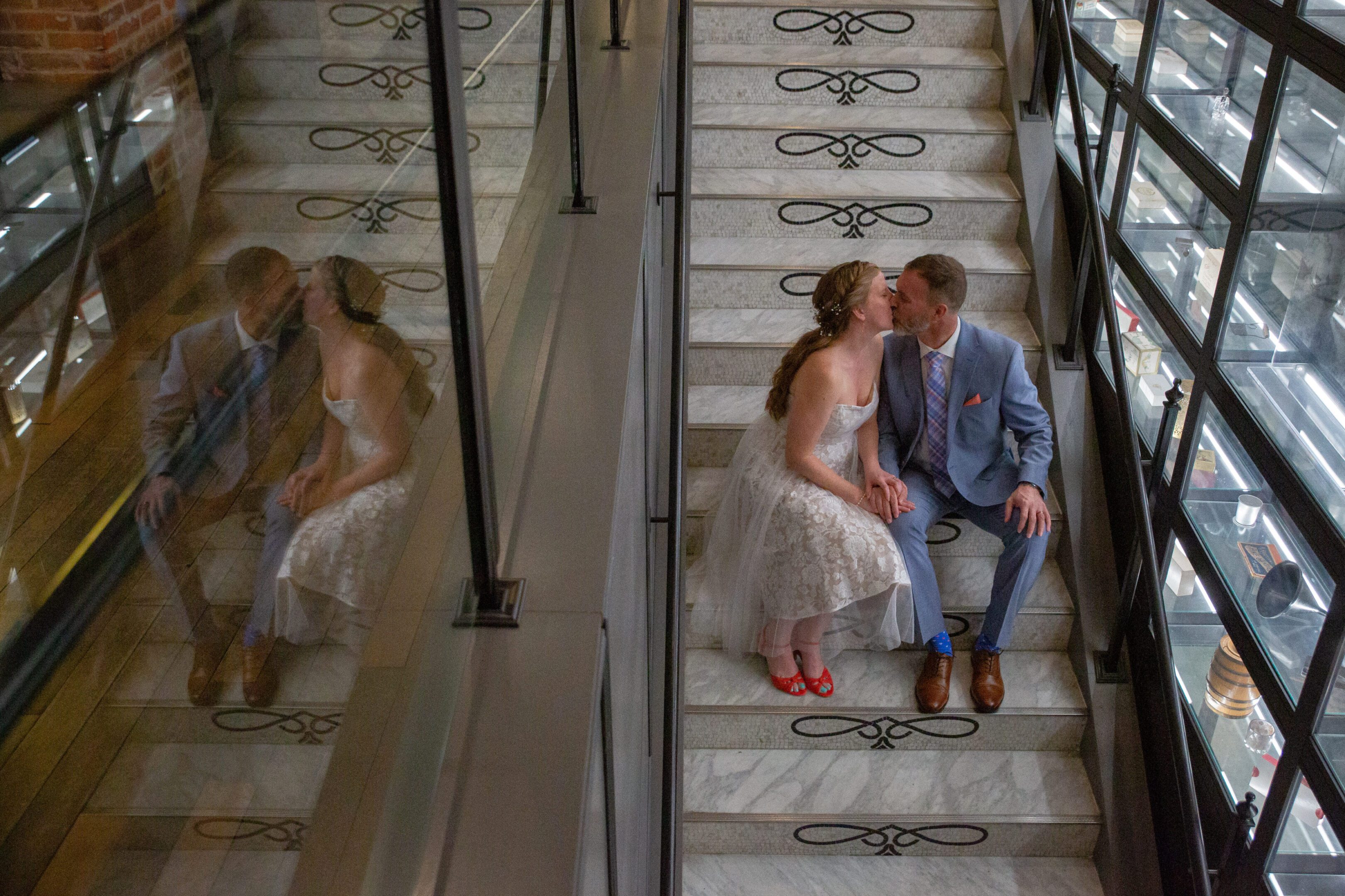 Bride and groom kissing on decorative staircase