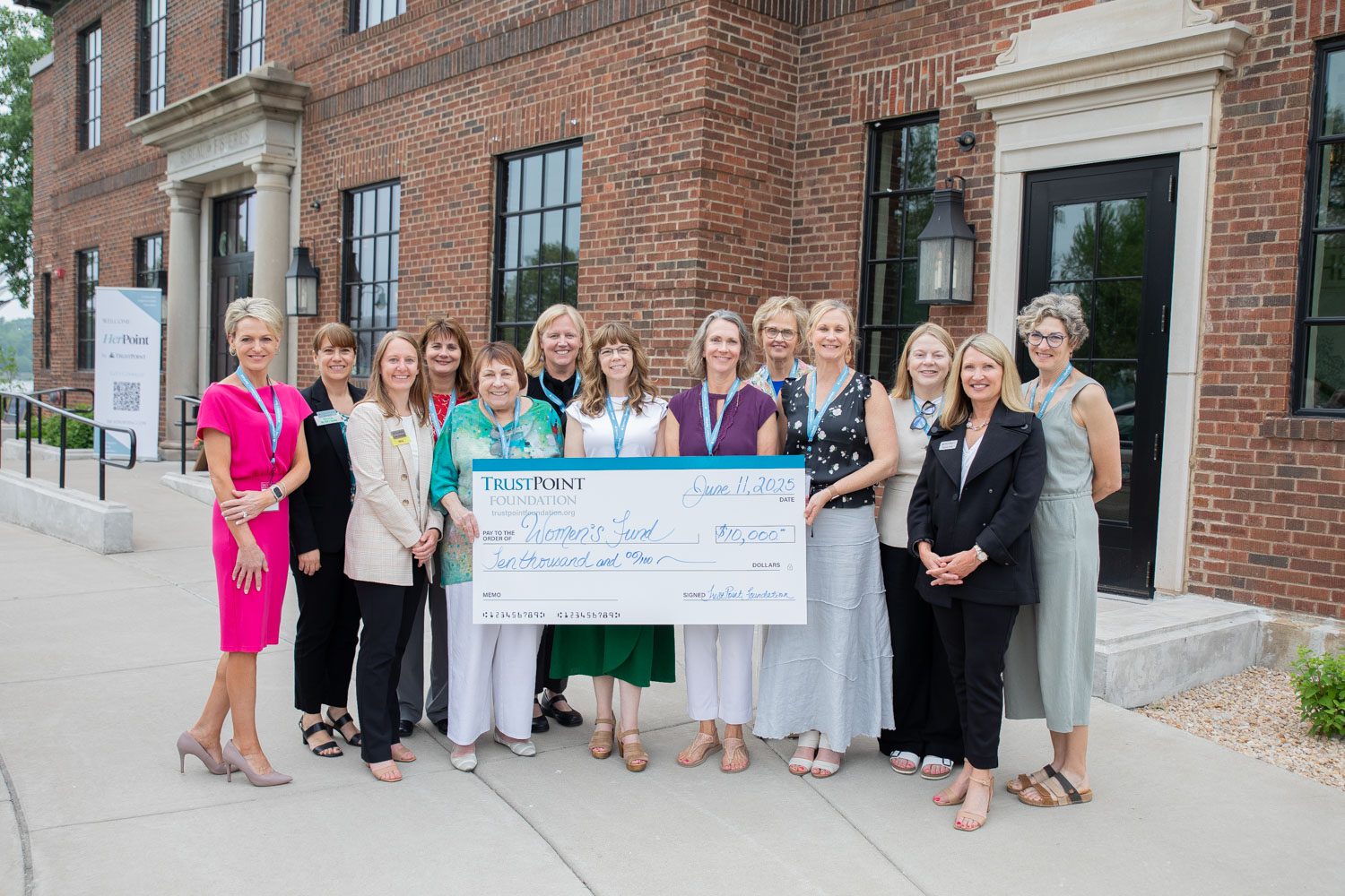 The Women's Fund received a generous donation and showed off the large check.