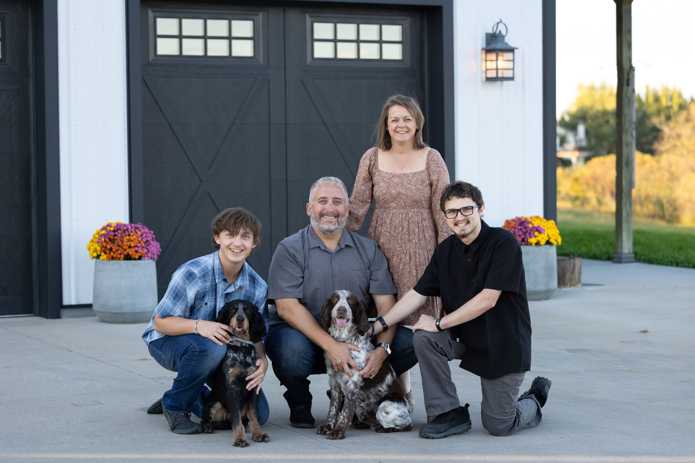 Family poses with their two adorable dogs for their annual family portrait.