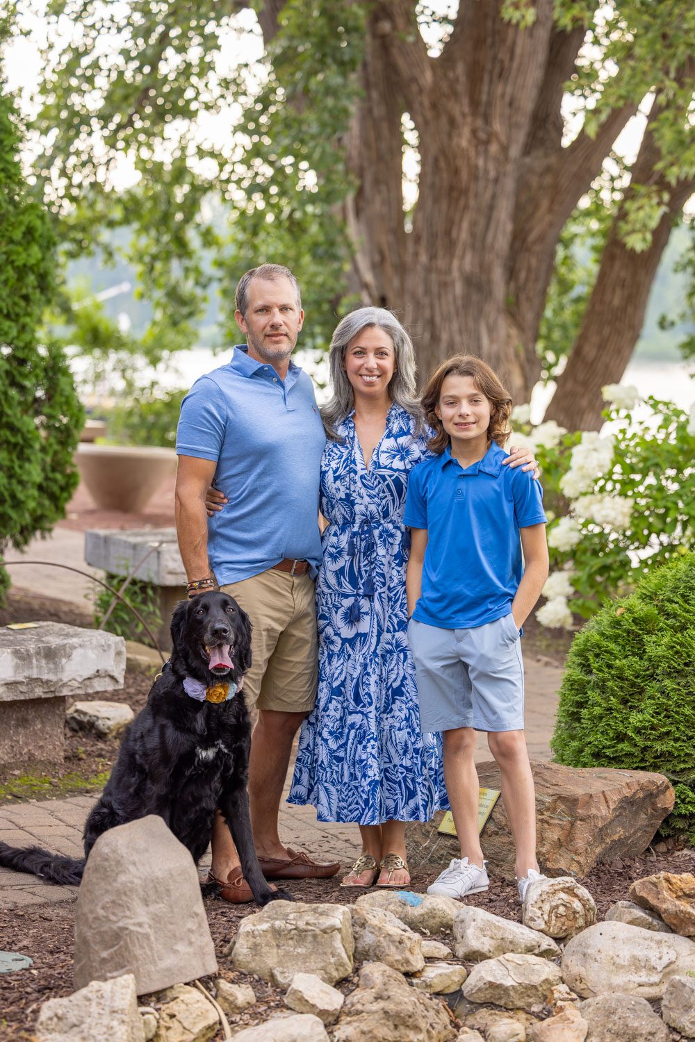 Family of four looking handsome in matching blue outfits.