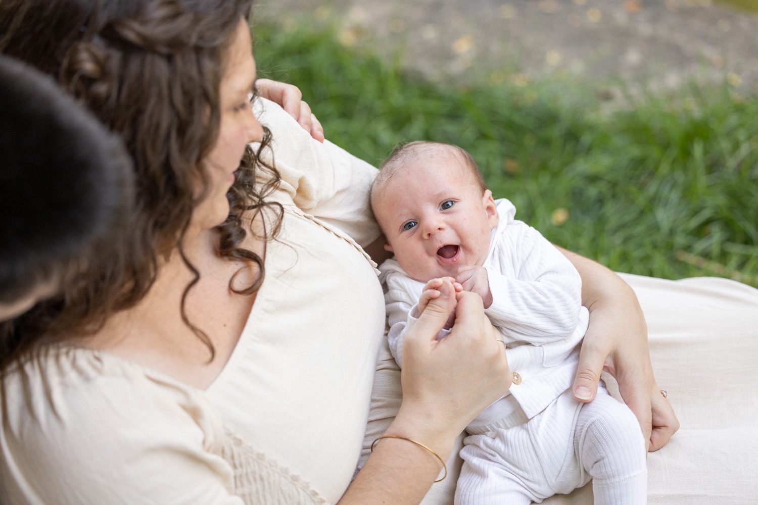 The new baby is pretty happy in his momma's arms.